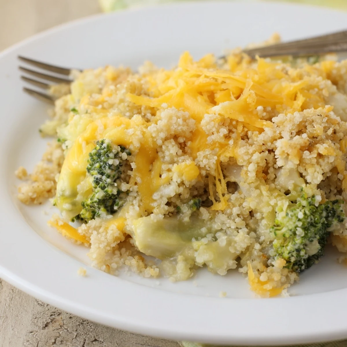 Golden baked creamy broccoli quinoa casserole with melted cheddar on top
