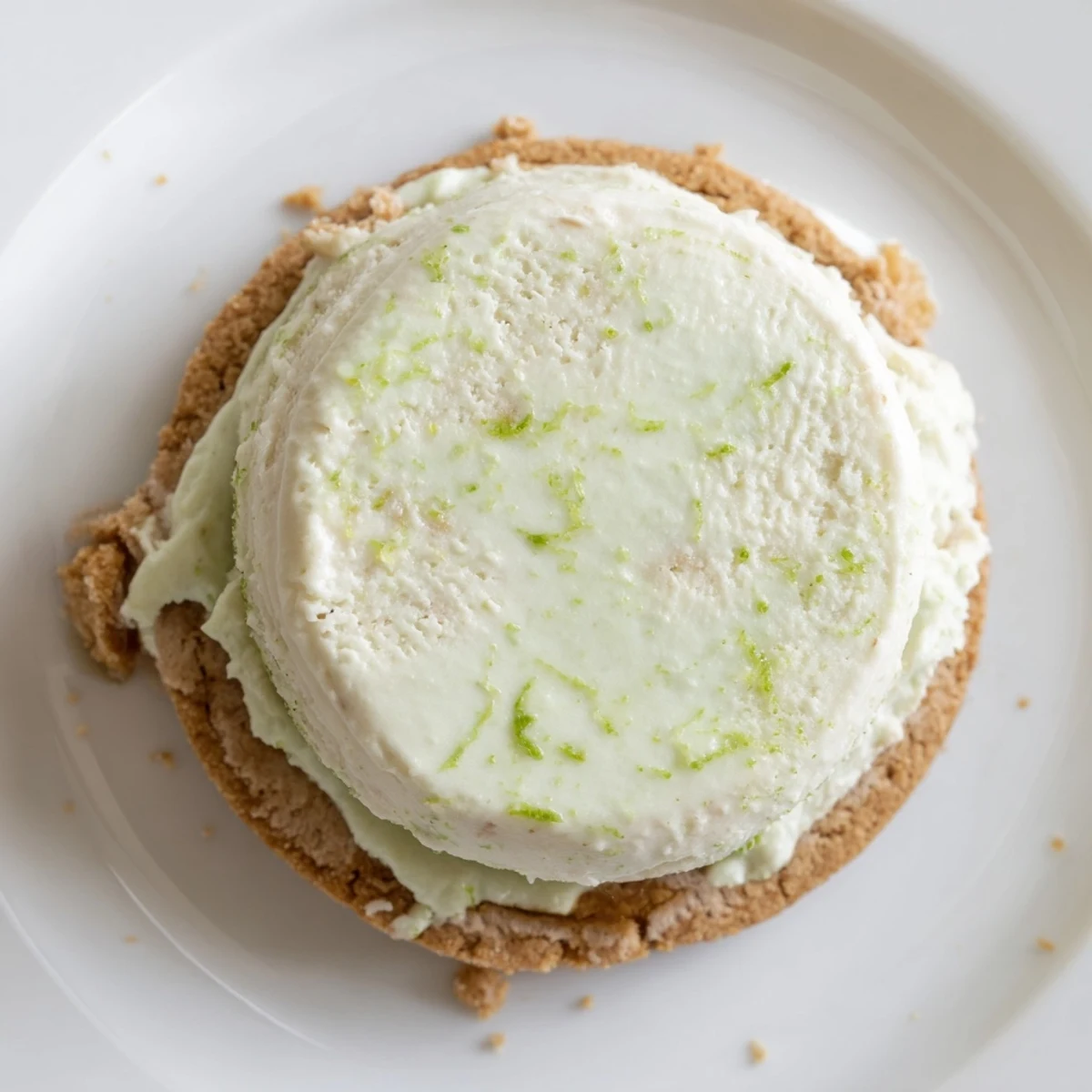 Homemade Key Lime Pie Ice Cream Sandwiches showing creamy, tangy center and golden cookies