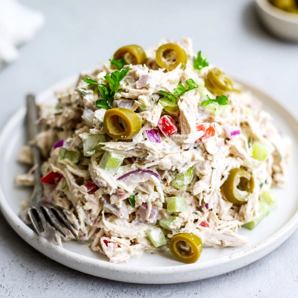 High Protein Pepperoncini Chicken Salad spooned onto a whole grain wrap, tangy crunch