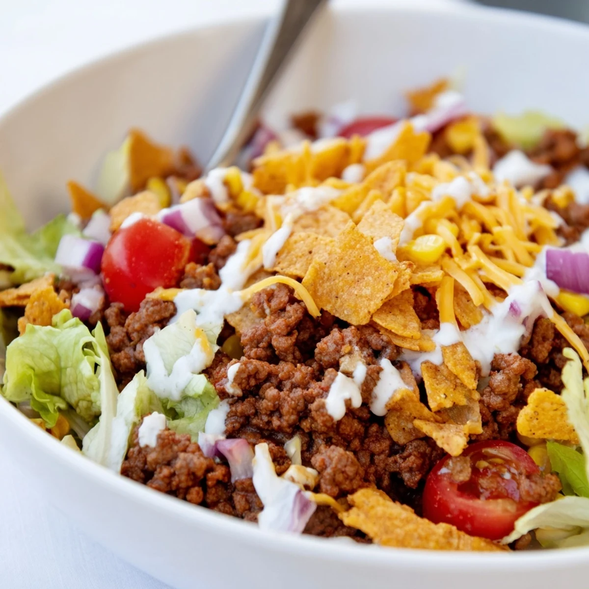 Simple Doritos Taco Salad tossed right before serving for extra crispy chips