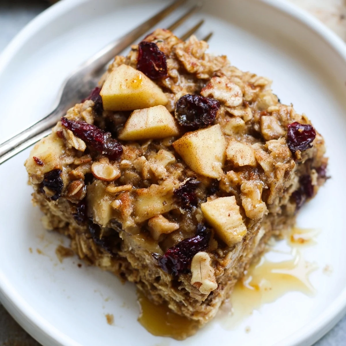 Golden-brown Delicious Apple Cinnamon Oatmeal Bake Recipe For Mornings topped with chopped walnuts.