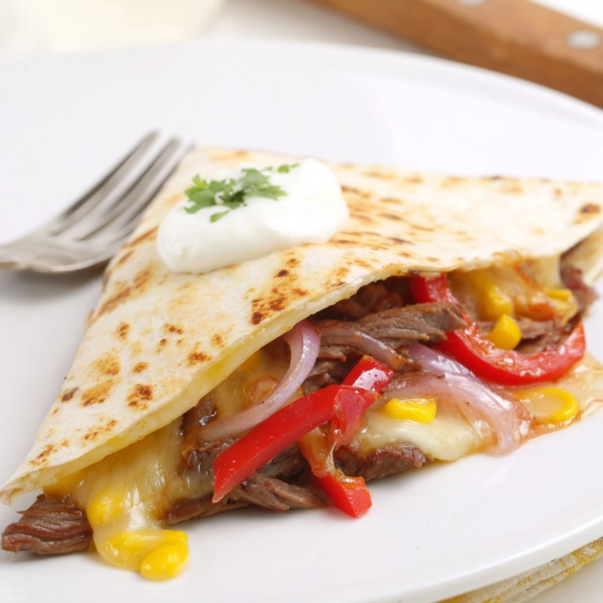 Warm Sweet Savory Beef Quesadillas sliced into wedges, served with lime and cilantro