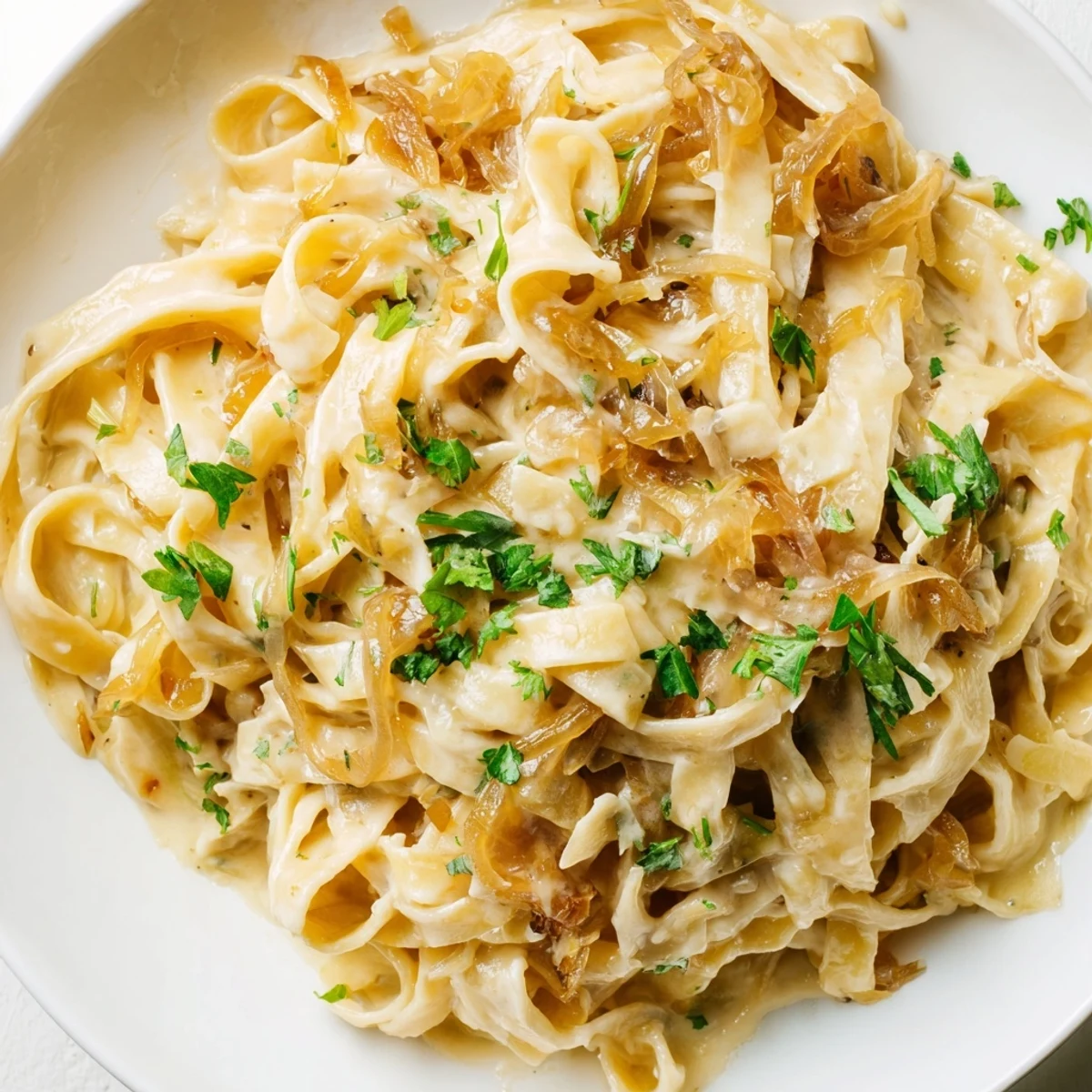Golden brown caramelized onions swirl through creamy caramelized onion cream pasta topped with fresh parsley